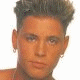 Three distinct pixelated headshots of a person with styled hair, each in separate quadrants against varying backgrounds.
