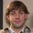 Static 48x48 pixel icon showing a person with light brown hair and neutral expression wearing a collared shirt, cropped to head/shoulders on beige background.