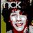 Pixelated image of a smiling face with red hair and white skin, set against dark background with partial text above.