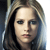 Pixelated close-up of a person with light brown hair, neutral expression, and visible eyes, nose, and mouth against a blurred background.