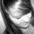 Black-and-white pixelated image of a person with dark hair and closed eyes, showing partial facial features and a smooth background.