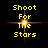 Yellow pixelated text 'Shoot For The Stars' arranged vertically over a central glowing starburst on a black background.