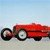Red vintage car with large black tires on light gray ground under light blue sky, pixelated style