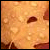 Pixelated static image with warm orange and brown tones, featuring a small dark brown shape near the center-right against a textured background.