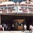 A pixelated static image of a theater facade with a dark interior and indistinct architectural details.