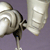 Pixelated image of a white and black object with a rounded top and a narrow stem against a purple background.