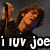 Pixelated image of a person with brown hair holding an object near their face, wearing dark clothing and purple accents, with text reading 'i luv joe' at the bottom.