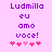 Purple text 'Ludmilla eu amo voce!' on light pink background with pink hearts, two versions showing heart position differences.