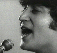A 5x5 contact sheet of black-and-white animated frames showing John Lennon singing into a microphone, with repeated "john lennon" text overlays in various styles across the grid.