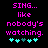 Pixelated text reads 'SING... like nobody's watching.' with cyan heart symbols below, displayed in two identical side-by-side on a black background