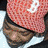 Pixelated buddy icon featuring a person wearing a red patterned cap with white logo and dark clothing, alongside black background with pixelated text "G-unit South".