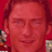 Static 48x48 pixel icon with red background showing a person's face and partial shoulders, featuring visible dithering and low-resolution rendering artifacts.