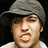 Pixelated image of a person wearing a gray beanie and light-colored shirt with text blocks surrounding the figure.