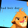 A cartoon lion cub with messy orange fur and a frustrated expression appears against a light blue background with the text 'bad hair day' in dark gray letters.