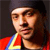 A pixelated close-up of a person wearing a red garment with blue and yellow stripes, set against a dark background.