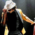 A four- shows a person in various poses: singing into a microphone, wearing sunglasses and a gray shirt; holding a white hat with long hair; making a hand gesture with an open mouth