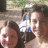 A static image with a red background, featuring a small photo of two people on the top-left and yellow pixelated text in three sections.