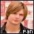 Pixelated static image of a person with light brown hair wearing dark clothing against a pink and white patterned background, with "Fan" text in the bottom right corner.
