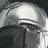 Pixelated grayscale image of a helmet with visible light reflections and dark structural details, likely from a video game character or military gear.