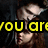 A pixelated image of a person with long brown hair and dark clothing, overlaid with yellow text reading "you army my life" in the top half and "now" in the bottom left.