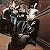A 2x2 contact sheet of a pixelated animated icon featuring four frames showing a character with dark hair and a mask-like face, alongside red text reading "MY Chemical Romance" on a black background.