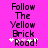 Pixelated text on bright pink background with white sparkles, displaying 'Follow The Yellow Brick Road!' in dark purple letters.