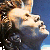 Two side-by-side pixelated images of a person with long hair, one showing light skin tones and blue background, the other warm orange-yellow tones.