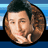 Pixelated circular portrait of a person with brown hair and light skin, next to blue background with text 'ADAM Sandler.com' in block letters.