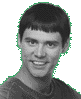 A grayscale portrait of a person with short dark hair and bangs, wearing a dark shirt against two different backgrounds.