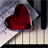 Static 48x48 pixel icon featuring a red heart-shaped object on piano keys with gray background and black vertical elements.