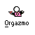 Pixelated character with white spherical head, pink torso, black arms, and red accents holding a black object, under text "Orgazmo" on gray background.