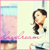 A static image shows a woman with long brown hair wearing a white top, with pink text reading 'daydream' overlaid on a blurred background.