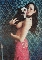 Pixelated static image of a woman in a red dress holding a white dog against a blue-tiled background.