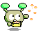 Pixelated green alien-like character with large white eyes, holding a yellow box with orange and white patterned contents, emitting orange particles from its left hand.