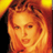 Pixelated static image of a person with light brown hair and warm orange-yellow tones against a dark background, rendered in low-resolution 48x48 pixels with visible dithering and color blending.