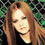 A static pixelated image of a person with long brown hair wearing a black top against a green and black checkered background.