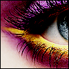 Close-up of a human eye with long, dark eyelashes, purple and yellow eyeshadow, and a grayish-blue iris, rendered in pixelated style.