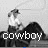 Pixelated grayscale image of a figure in cowboy attire standing on rocky terrain with the word 'cowboy' overlaid at bottom.