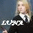 A pixelated image of a person with light hair in dark clothing, overlaid with white text and a stylized musical note graphic.