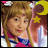 Pixelated image of a person with long brown hair wearing a pink and blue outfit holding a yellow star and crescent moon prop.