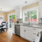 A pixelated static image showing a blurred interior scene with indistinct furniture and greenery visible through a window.
