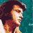 Pixelated static image of a person with dark curly hair and light skin in profile view against a teal background, wearing an orange-brown top.