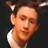 A static image with a maroon background, featuring a small photo of a person in the top-left corner and golden text reading "Smart is sexy.".