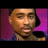 Pixelated portrait of a person with light brown skin tone, closed eyes, and short dark hair against purple background.