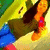 Pixelated figure with brown hair, dark clothing, and blue lower body against yellow-green background.