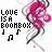 Pixelated pink character with red hair and white limbs in dynamic pose, text 'LOVE IS A BOOMBOX' with musical notes on white background.