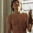 A shirtless man with short dark hair stands in a doorway, holding a bottle in his right hand, with the word 'Hottie' in yellow text overlaid on the right side.