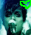 Pixelated image of a person with dark hair and greenish skin tone, mouth open in an exaggerated expression, wearing white clothing against a blue background.
