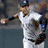 Animated sequence showing a baseball player in white uniform with dark cap and belt, first throwing ball then swinging bat on field.