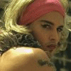 A person with blonde hair and a pink headband appears in multiple poses, some showing text overlays like 'Johnny's' and 'A MAN'S MAN'.